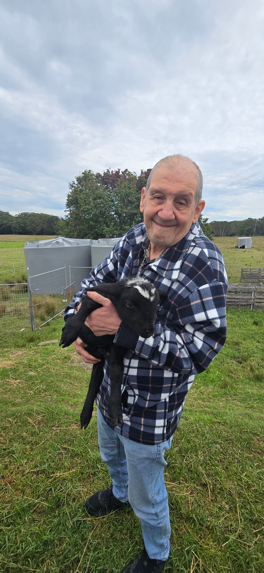 A participant holding a lamb on a farm visit