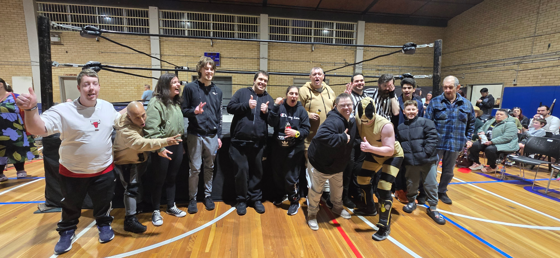 The group cheering together at a live wrestling event