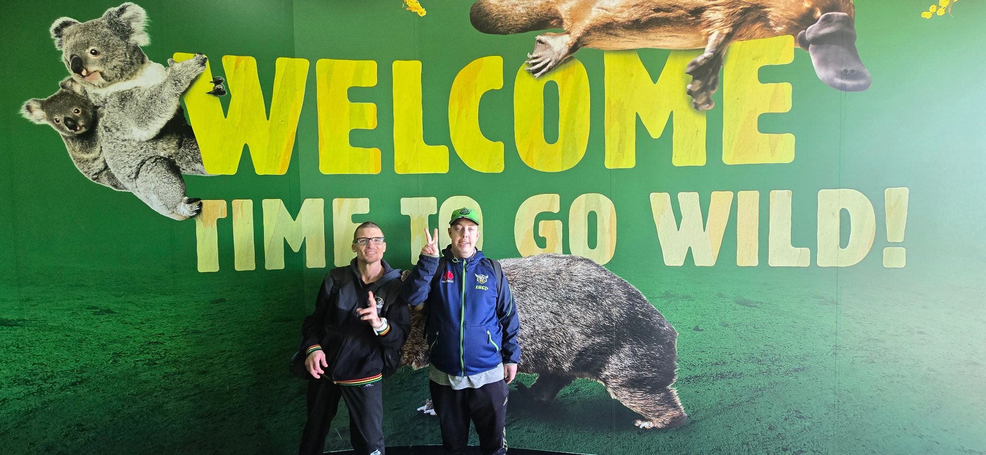 Two mates posing at the entrance of a wildlife park