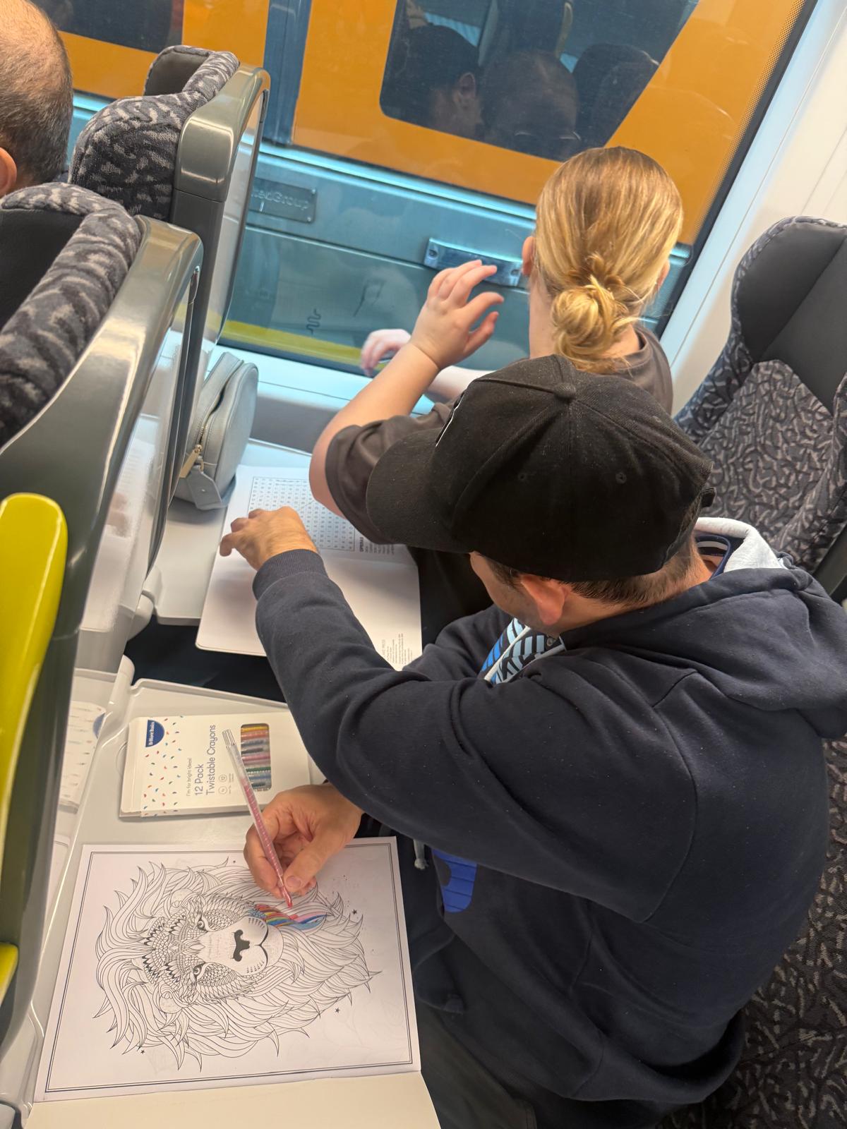 Participants colouring in and doing puzzles on the train