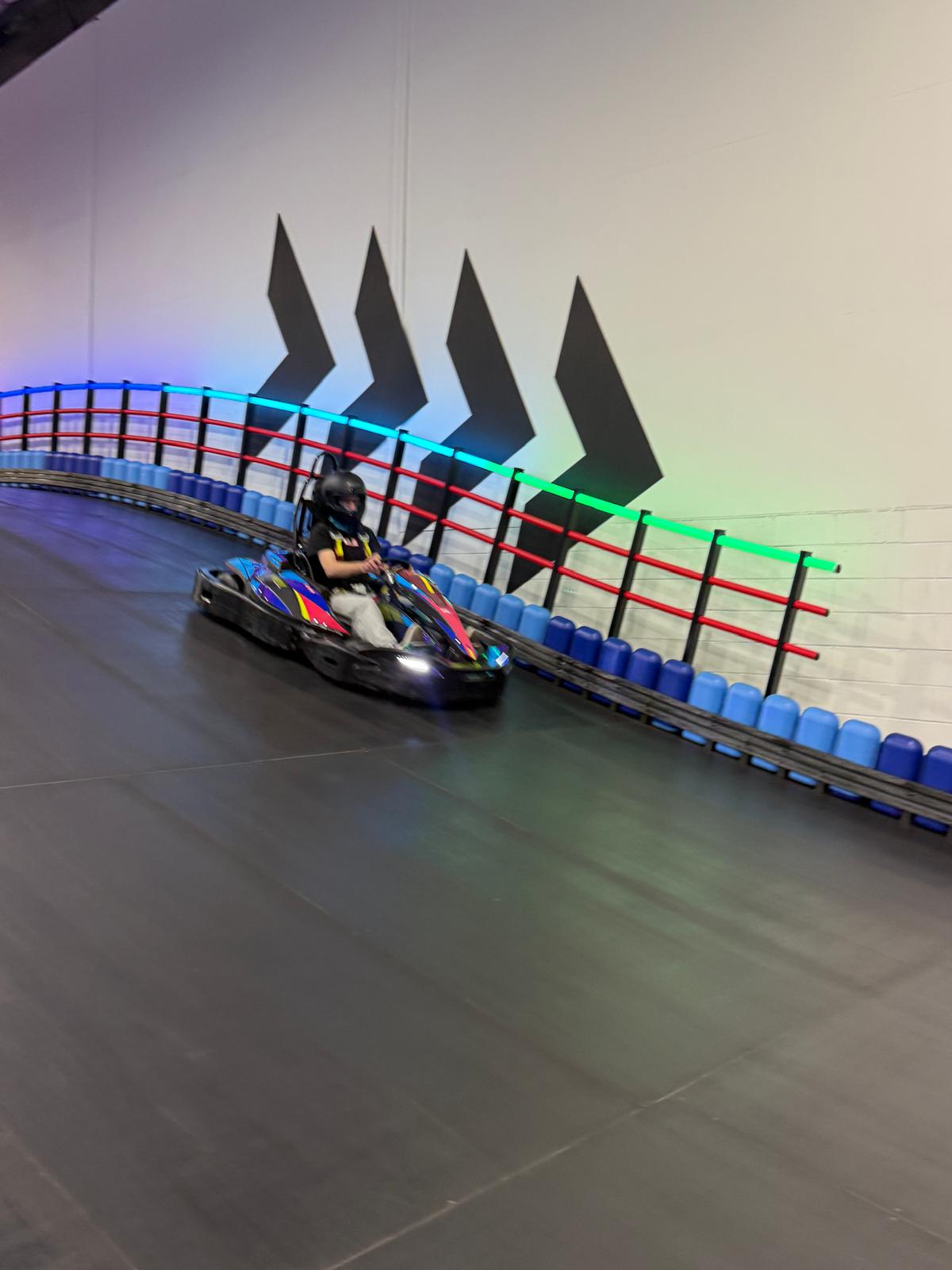 A participant speeding around the go-kart track