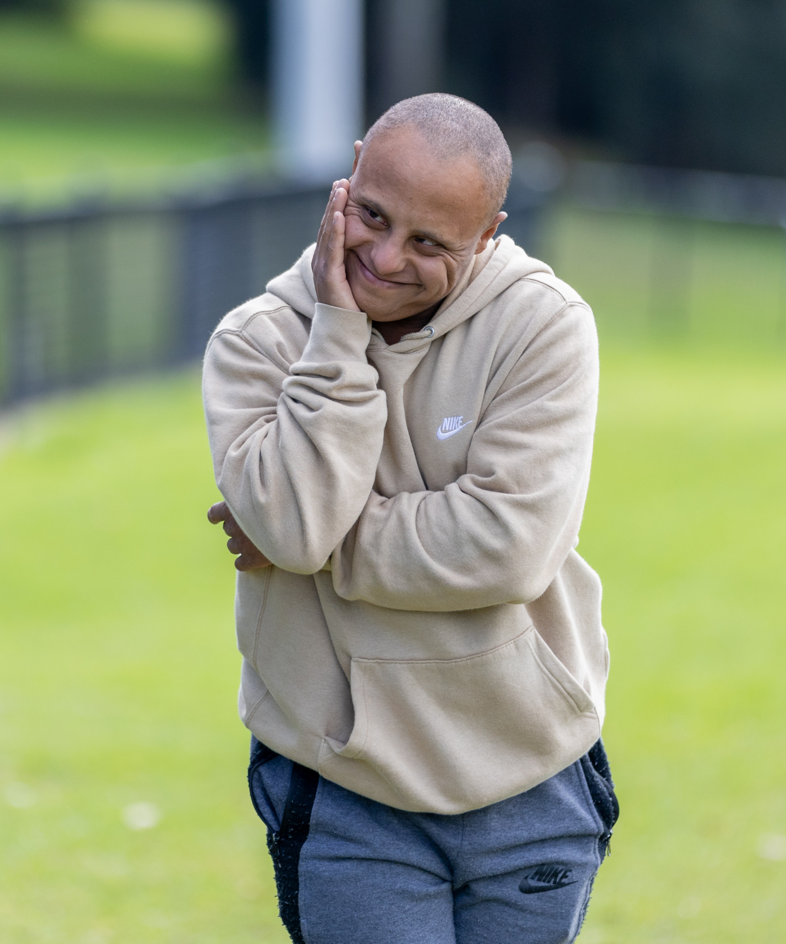A participant smiling warmly in a park