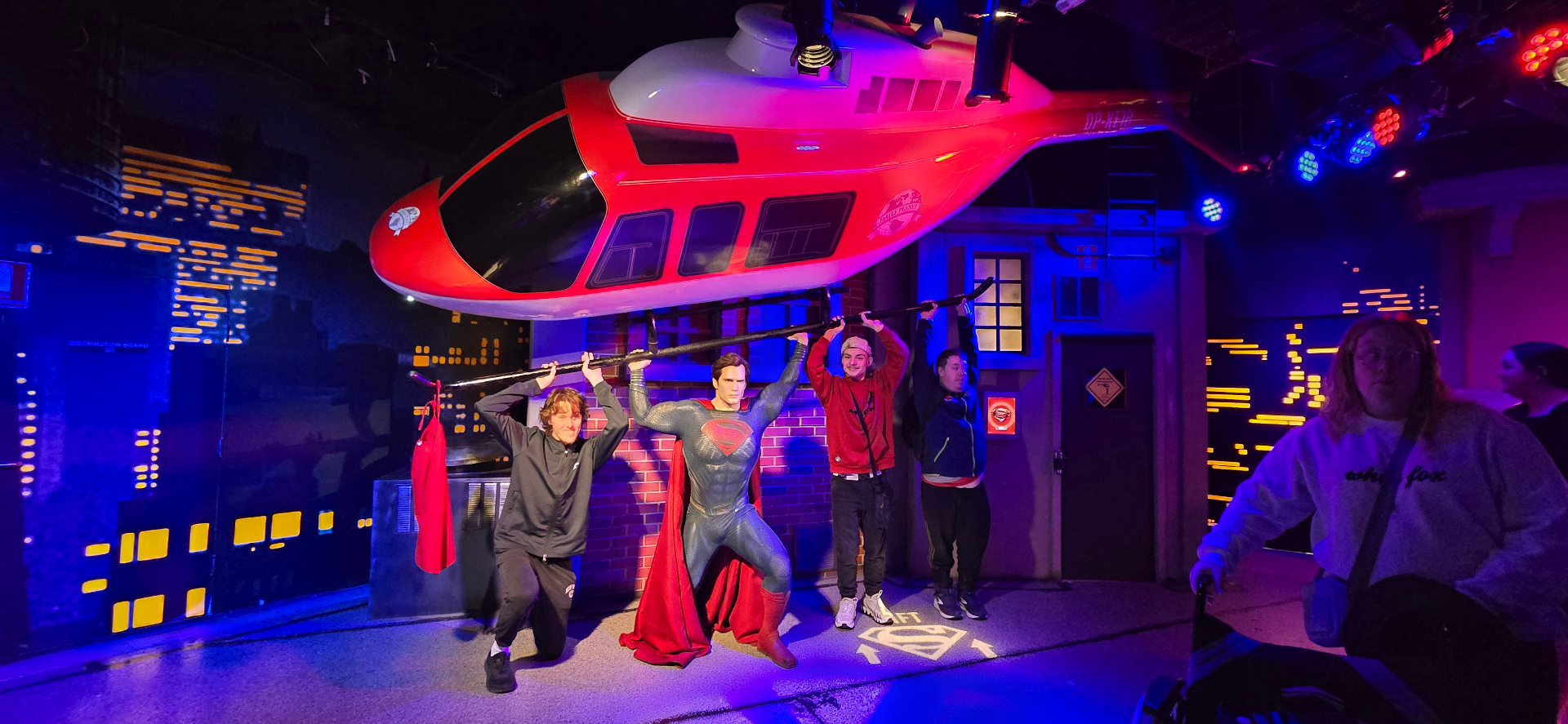 Participants posing with a superhero display on a day out