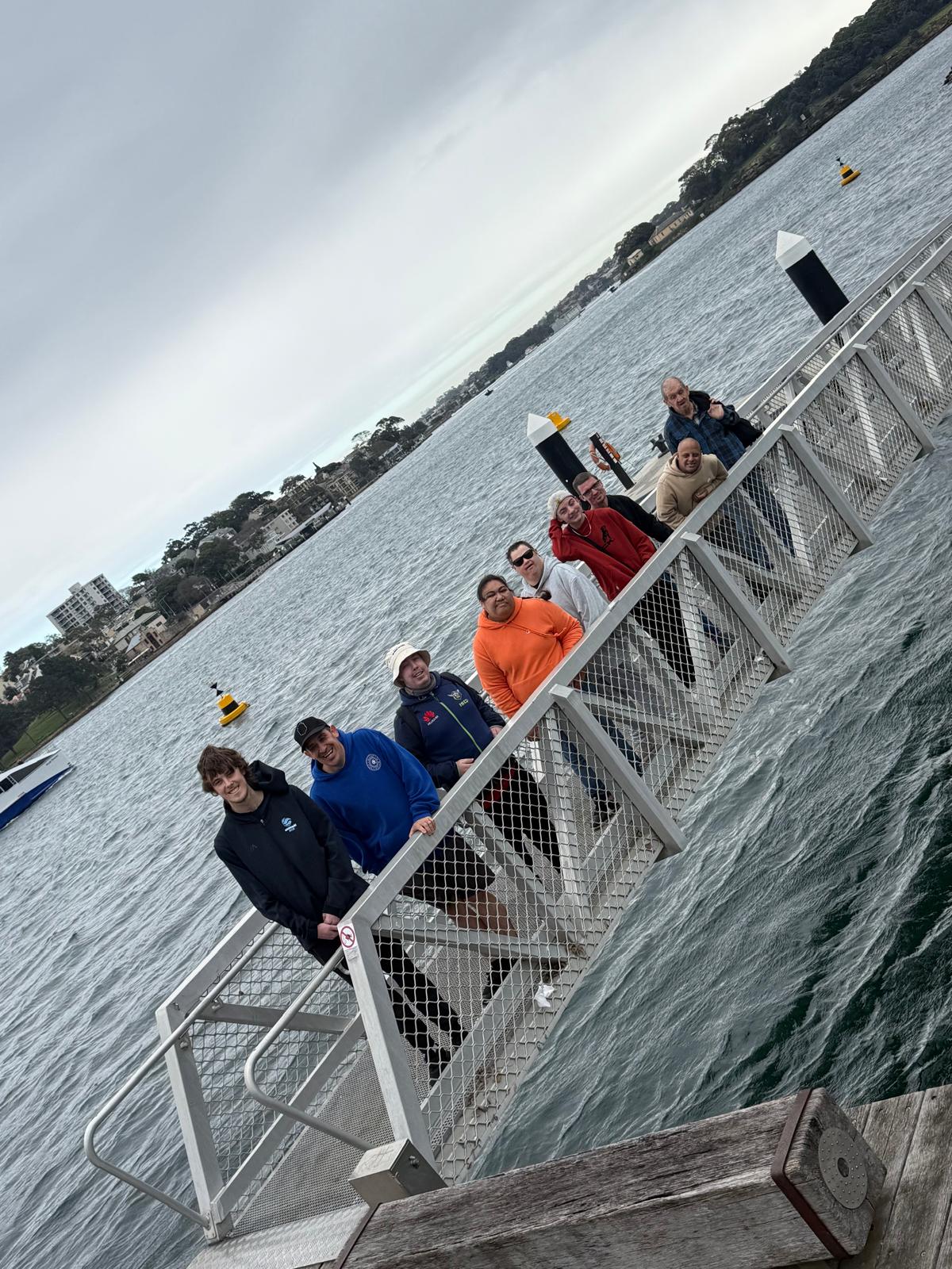 The group waiting on the wharf gangway before a ferry ride